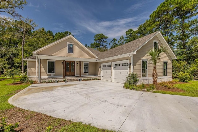 view of front of property with covered porch and a garage