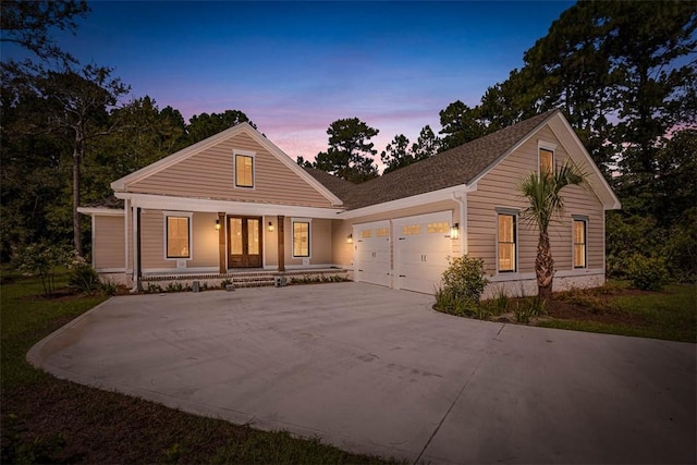 view of front of property with covered porch and a garage