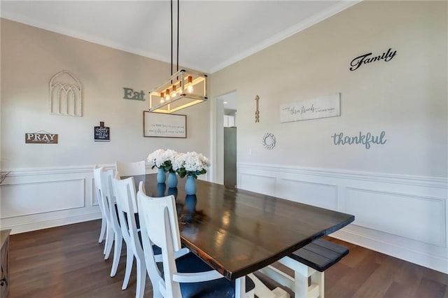 62 Wellington Cir, Brunswick, GA 31525 - dining area with a chandelier, a decorative wall, wainscoting, crown molding, and dark wood-type flooring