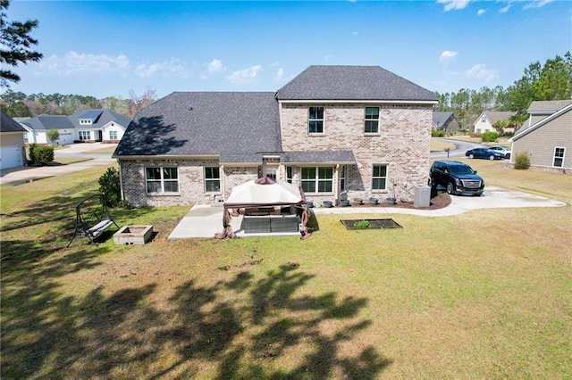 62 Wellington Cir, Brunswick, GA 31525 - rear view of property featuring a gazebo, a patio area, brick siding, and a lawn