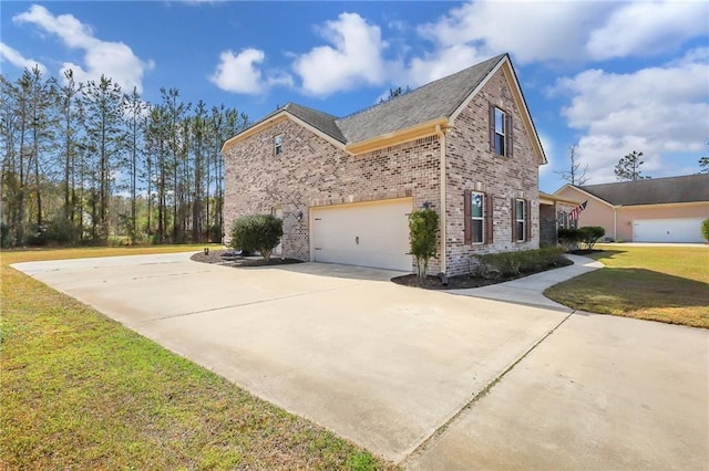 62 Wellington Cir, Brunswick, GA 31525 - view of side of home with brick siding, an attached garage, driveway, and a lawn