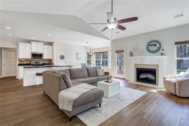 62 Wellington Cir, Brunswick, GA 31525 - living room featuring dark wood-style flooring, ceiling fan, lofted ceiling, a premium fireplace, and recessed lighting