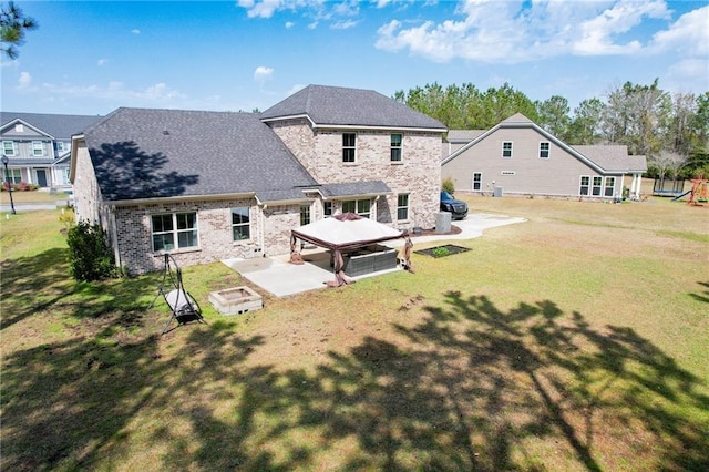 62 Wellington Cir, Brunswick, GA 31525 - rear view of house with a patio area, a lawn, and brick siding