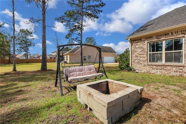 62 Wellington Cir, Brunswick, GA 31525 - view of green lawn featuring a fire pit and a residential view