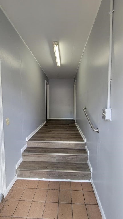 stairs featuring hardwood / wood-style floors