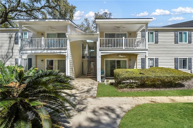 view of front of property featuring a balcony and ceiling fan