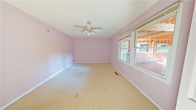 carpeted empty room with ceiling fan