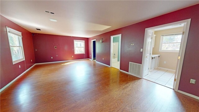 unfurnished room with light hardwood / wood-style flooring and a wealth of natural light