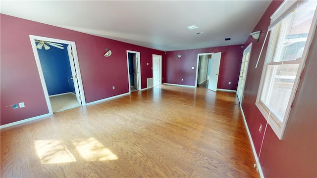 empty room featuring hardwood / wood-style floors and ceiling fan