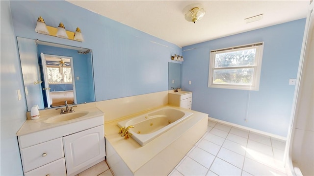 bathroom featuring tile patterned floors, plenty of natural light, and a bathing tub