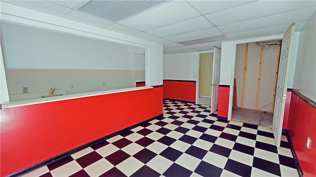 hallway featuring a paneled ceiling