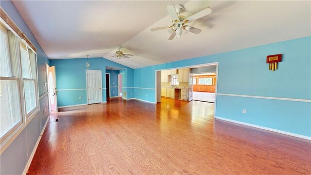 unfurnished living room with hardwood / wood-style floors, ceiling fan, and lofted ceiling