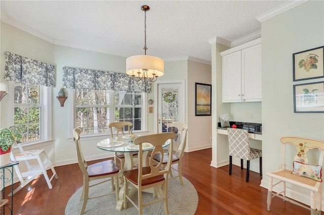 dining space with a notable chandelier, dark wood finished floors, ornamental molding, and a healthy amount of sunlight