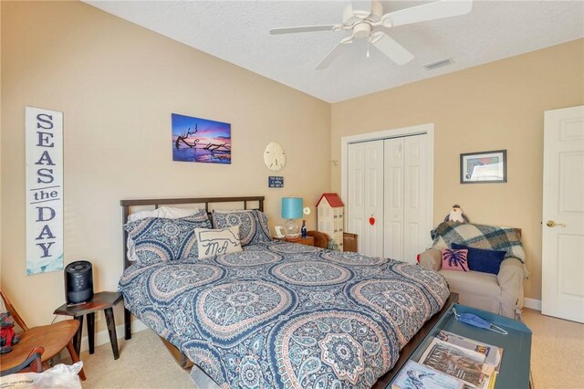 carpeted bedroom with a closet, visible vents, a ceiling fan, and baseboards