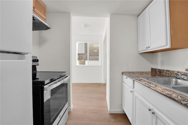 kitchen featuring white cabinetry, stainless steel electric range oven, sink, light hardwood / wood-style flooring, and white fridge