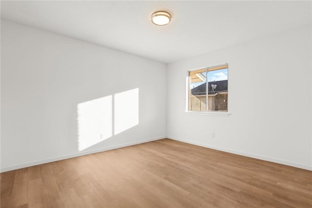 spare room with hardwood / wood-style floors