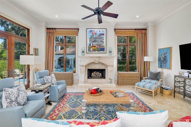 living room featuring a fireplace, a wealth of natural light, and crown molding