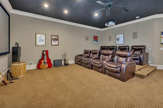 cinema room with carpet flooring, ceiling fan, and crown molding