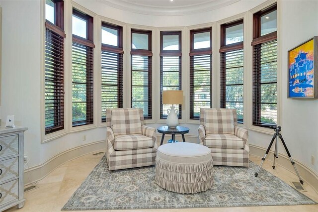 living area with crown molding