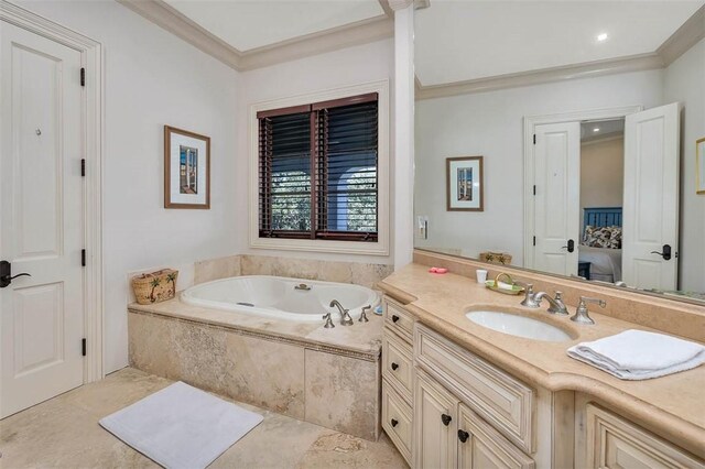 bathroom featuring tiled bath, crown molding, and vanity