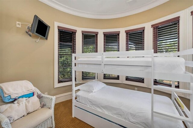 carpeted bedroom featuring ornamental molding