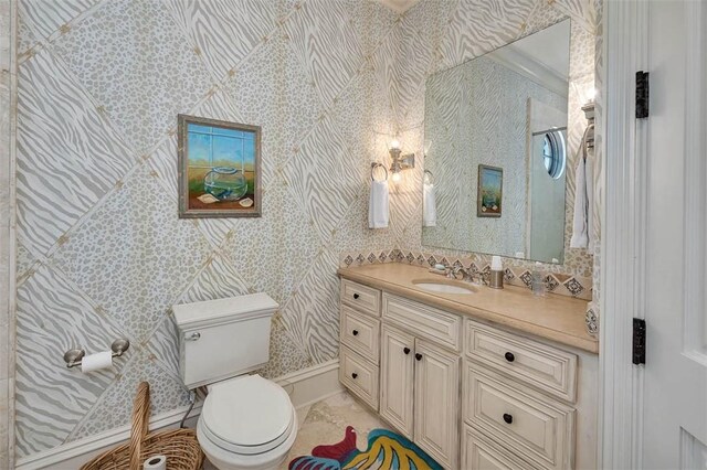 bathroom featuring crown molding, vanity, and toilet