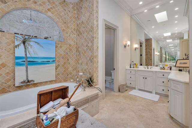 bathroom featuring a tub to relax in, a skylight, vanity, crown molding, and tile walls