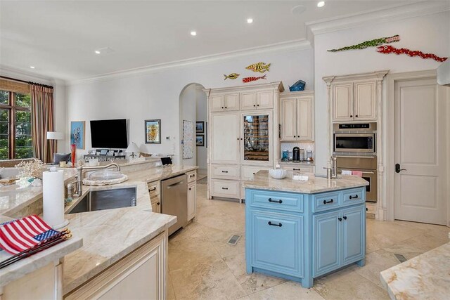 kitchen featuring light stone countertops, sink, dishwasher, a large island, and crown molding