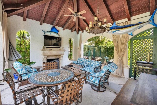 view of patio / terrace featuring ceiling fan and an outdoor fireplace