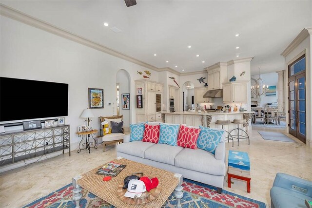 living room featuring ornamental molding and a chandelier