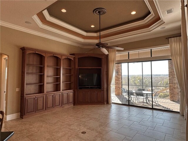 unfurnished living room featuring ceiling fan, a raised ceiling, and crown molding