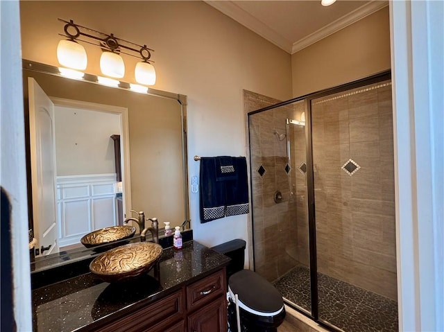 bathroom featuring walk in shower, vanity, and ornamental molding