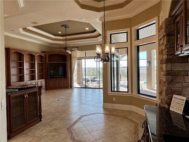 dining area with ceiling fan with notable chandelier, crown molding, and a tray ceiling