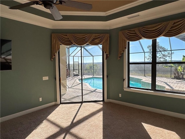 doorway featuring ceiling fan, dark colored carpet, and ornamental molding