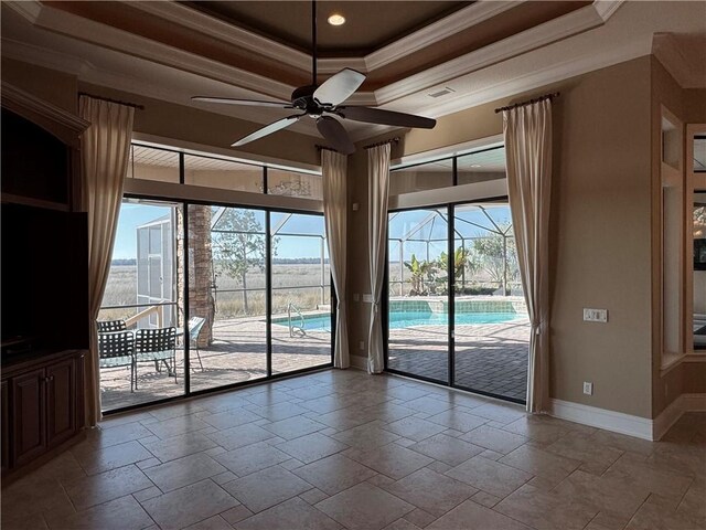 spare room featuring a raised ceiling, crown molding, and ceiling fan