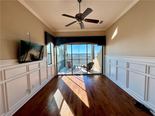 interior space featuring dark hardwood / wood-style floors, ceiling fan, and ornamental molding