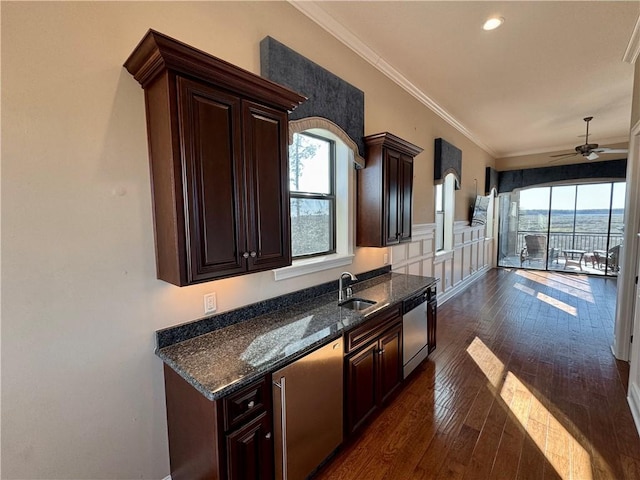 kitchen featuring stainless steel dishwasher, dark brown cabinetry, ceiling fan, crown molding, and dark hardwood / wood-style floors