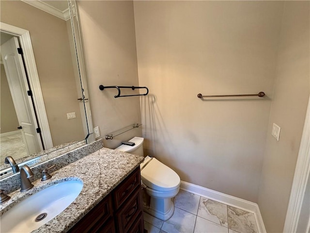 bathroom featuring vanity, toilet, and crown molding