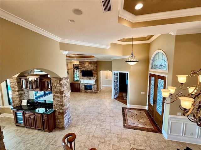 entrance foyer featuring french doors, ornamental molding, and a healthy amount of sunlight