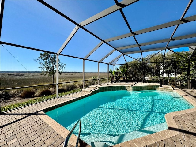 view of swimming pool with a patio area and a lanai