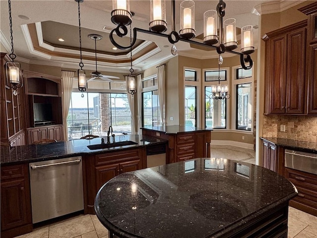 kitchen with dishwasher, a kitchen island, hanging light fixtures, and dark stone counters