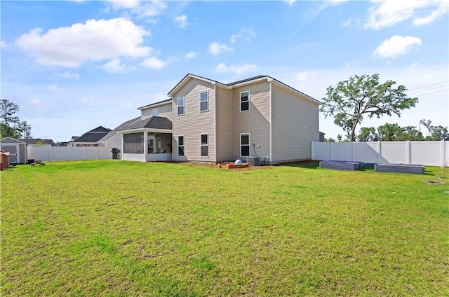 288 Chestnut Dr, Brunswick, GA 31523 - back of house with a sunroom, a fenced backyard, and a storage unit