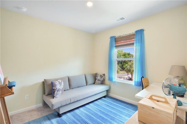 carpeted living room featuring baseboards