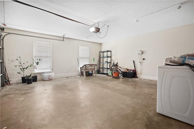 garage featuring washer / dryer and a garage door opener