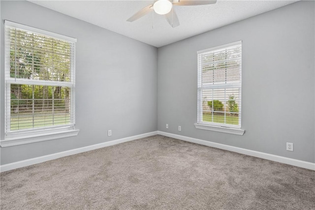 empty room with carpet and ceiling fan