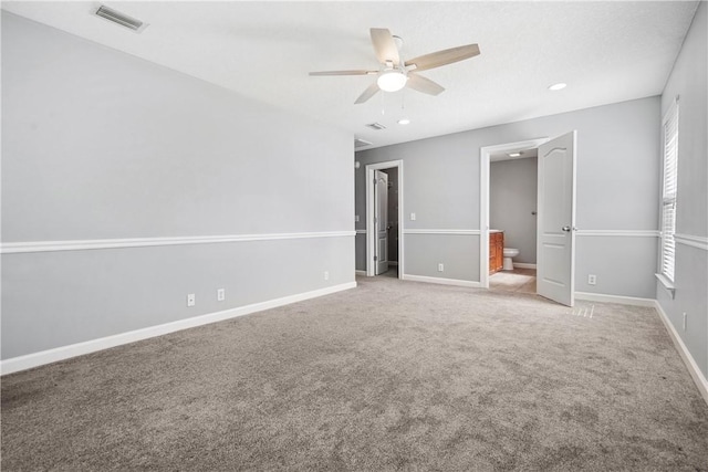 unfurnished bedroom with carpet flooring, ensuite bath, and ceiling fan