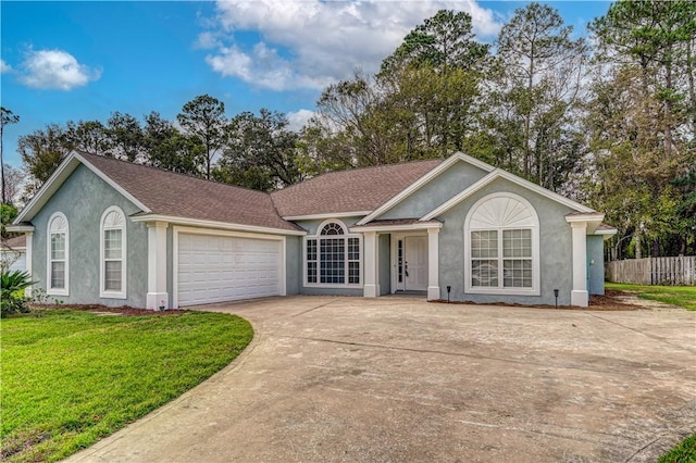 ranch-style house featuring a garage and a front lawn