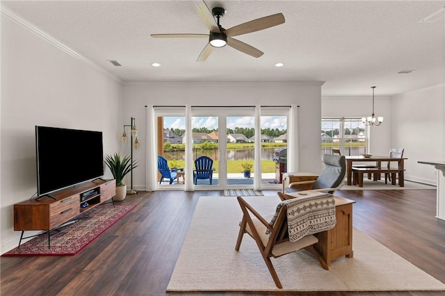 living room featuring a textured ceiling, crown molding, ceiling fan with notable chandelier, and dark hardwood / wood-style floors