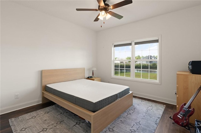 bedroom with ceiling fan and dark wood-type flooring