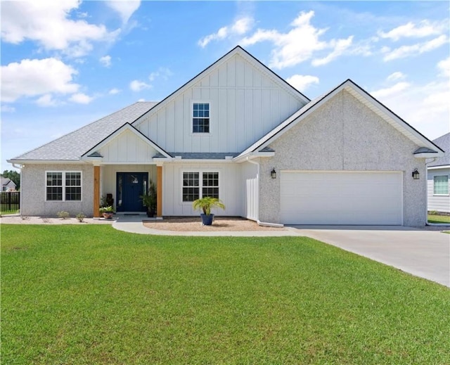 view of front of house with a garage and a front lawn